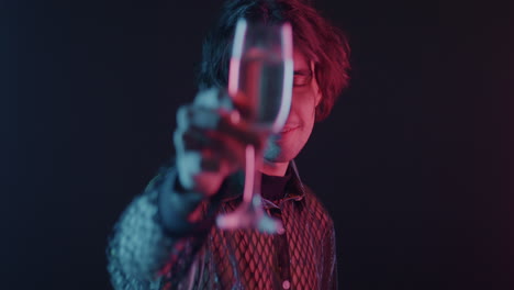 stylish man with champagne in neon light