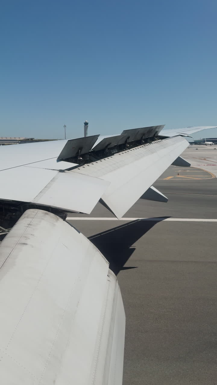 view from a plane window of the sky with the wing shot in vertical