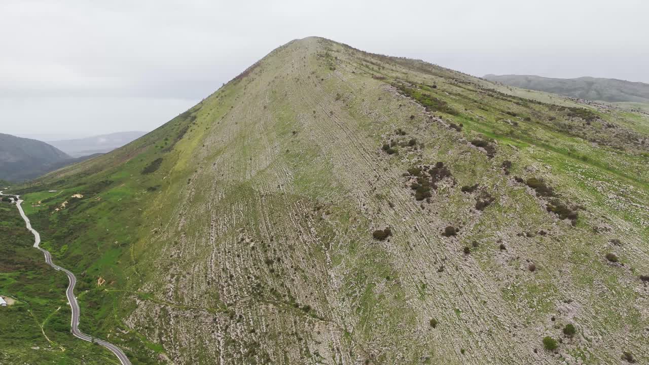Aerial view of Albania's serene green mountain landscape, peaceful mood