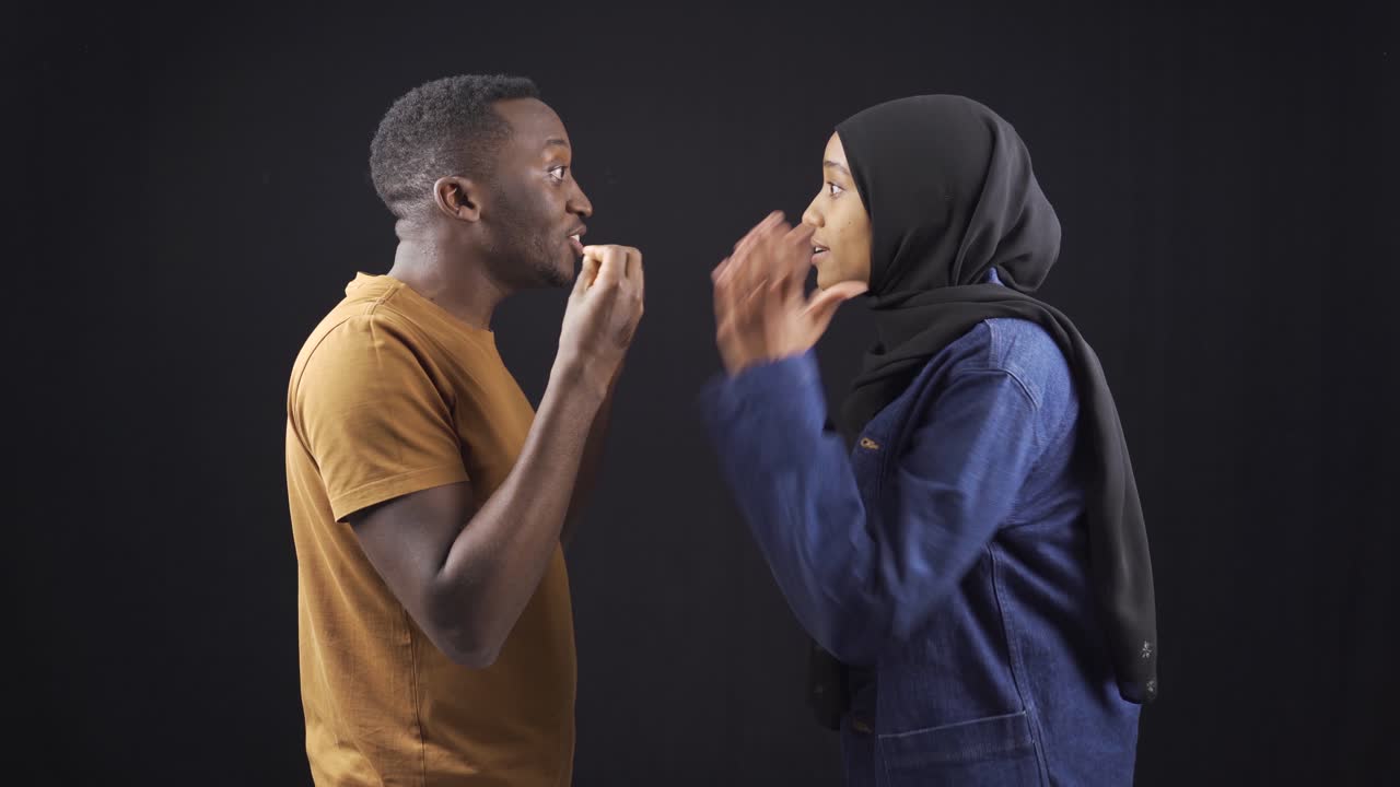Unhappy muslim african couple arguing and not listening to each other.