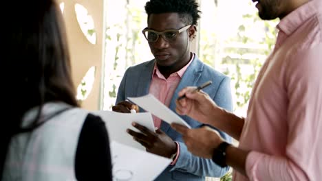 cheerful young people writing on paper