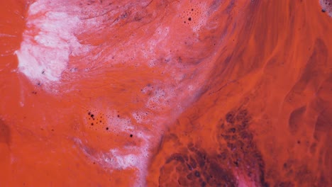 abstract fluid art in red, pink, and white