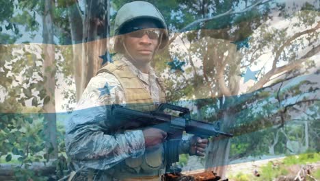 digital composition of waving honduras flag against soldier holding a gun at training camp