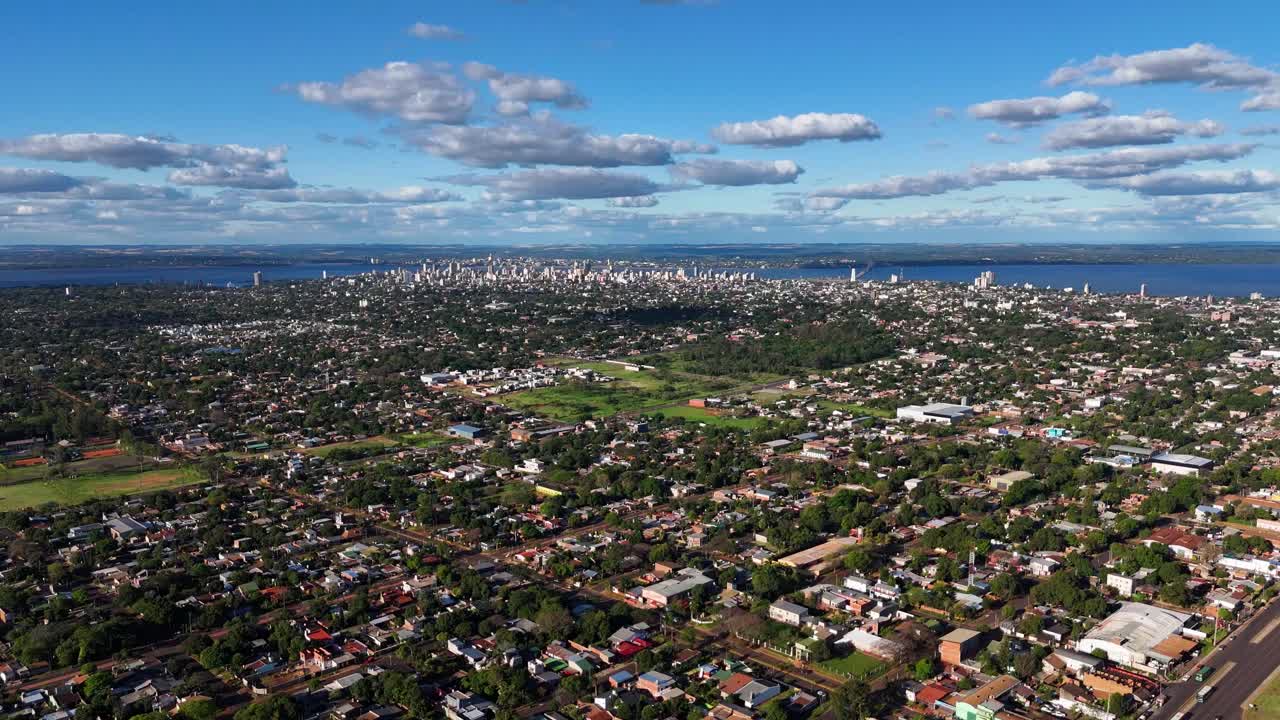 Aerial hyperlapse showcasing the charming city of Posadas, Misiones, Argentina, against a backdrop of beautiful clouds and a clear blue sky