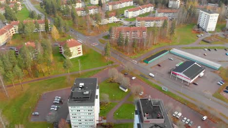 drone footage flying towards two 10 story buildings in a small town with some lower apartment house in the background