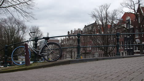 Bicycle-on-a-bridge-over-a-canal-in-Amsterdam