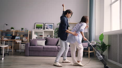 couple dancing while vacuuming