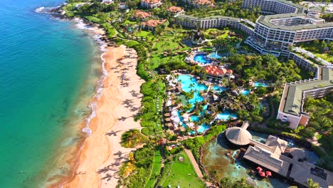 grand wailea resort with pools and sandy beach on the maui coast, aerial view