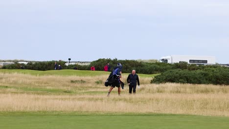 two golfers walking across the field