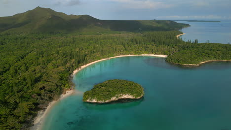 pic n'ga is the highest mountain peak on isle of pines, overlooking kanumera bay - ascending aerial