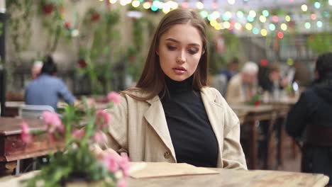 smiling girl investigating menu in a coffee