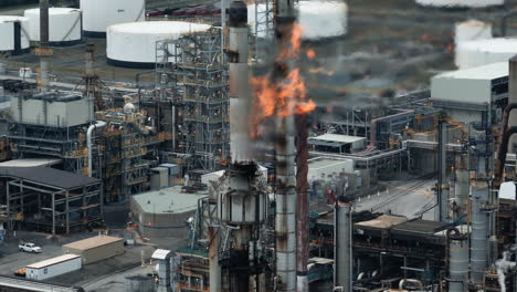 aerial view of flames in front of a gas refinery - oil production