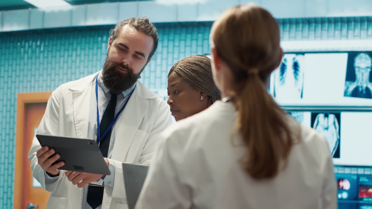 Medical professionals discussing x-rays on a tablet