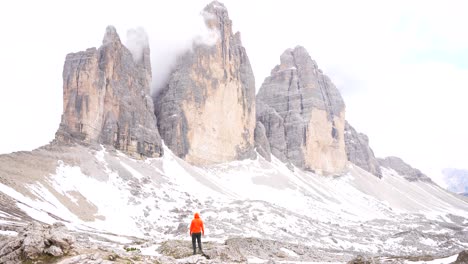 Personal-achievement-of-a-man-admiring-majestic-Tre-cime-di-Lavaredo-peaks