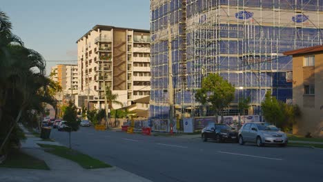 apartment building under construction at sunset