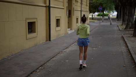 woman jogging on city street