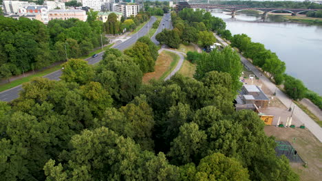 Aerial-view-of-a-Park-by-Vistula-River-on-Poniatowski-Bridge-in-Warsaw-Downtown