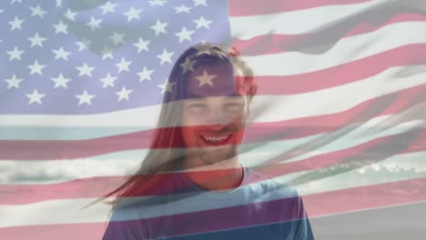 Animation-of-flag-of-united-states-of-america-over-happy-caucasian-man-on-beach