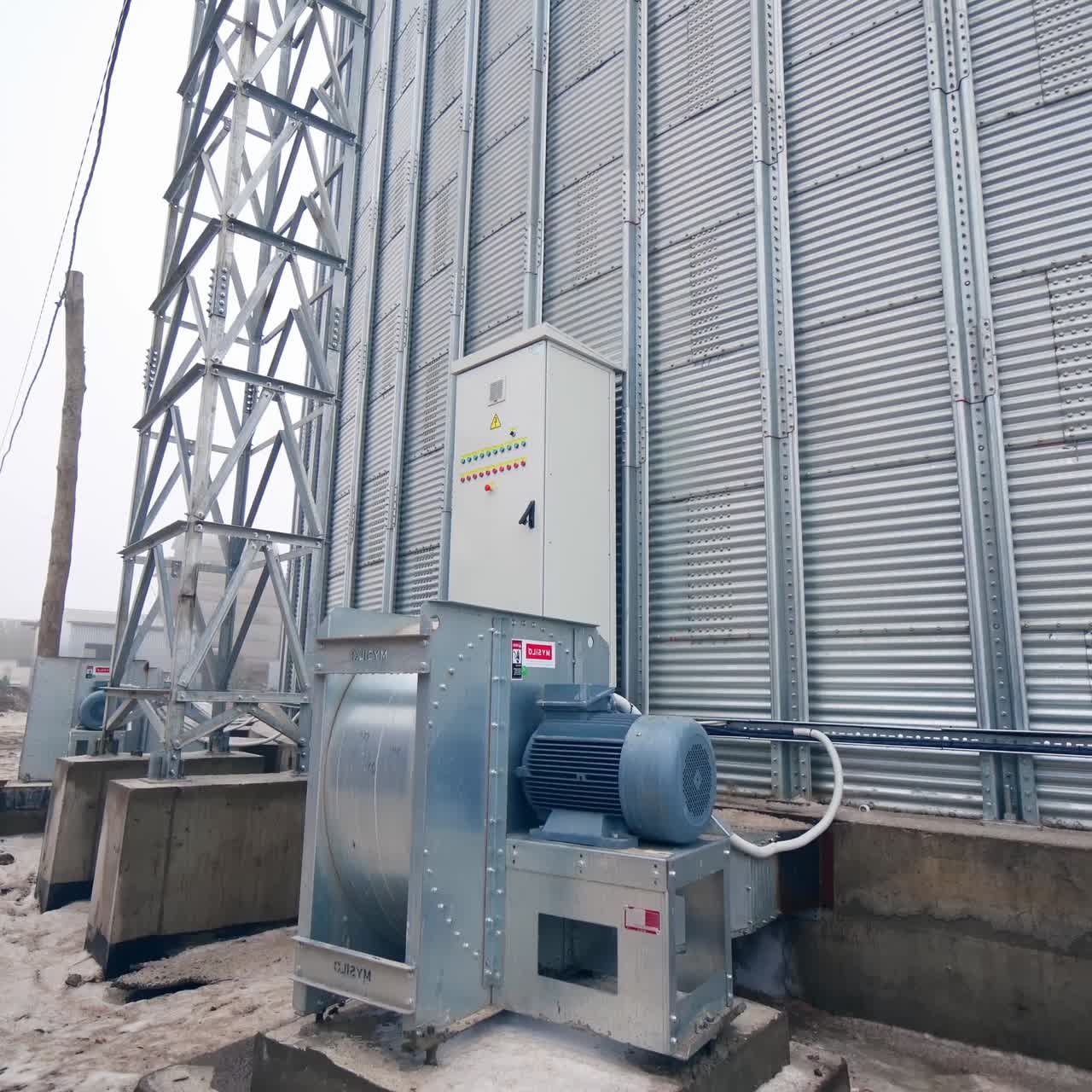 Work of an elevator with a generator. Steel grain silos for grain storage. Grain storage elevators with generator