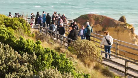 visitors walking along coastal boardwalk