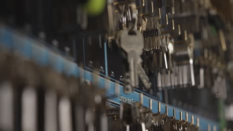 pan shot across a wall full of keys and pull focus onto a stack of keys