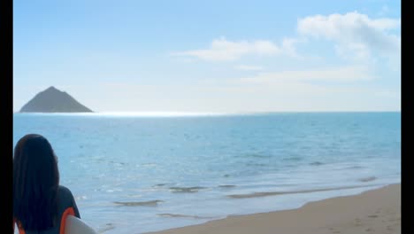 female surfer standing with surfboard in the beach 4k