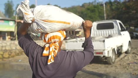 person carrying a sack on their head