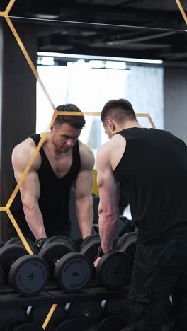 man training by lifting dumbbell