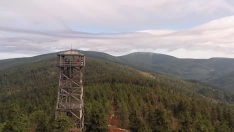 drone shot of watchtower on top of the hill with czech countryside in the background