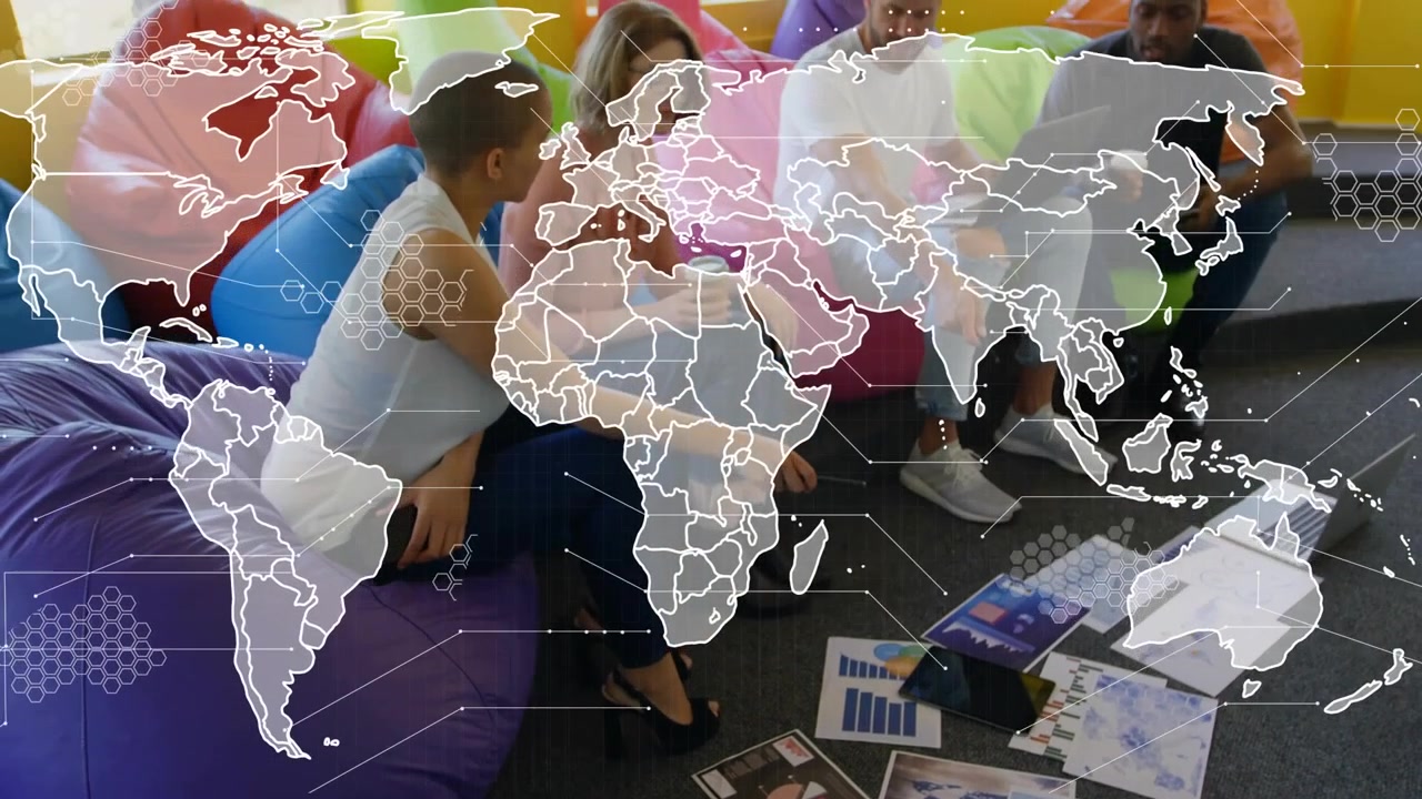 World map overlay animating, framing four colleagues exchanging charts and discussing business data