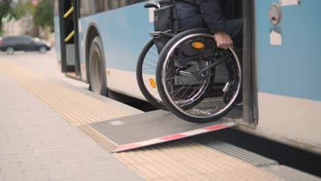 person with a physical disability enters public transport with an accessible ramp