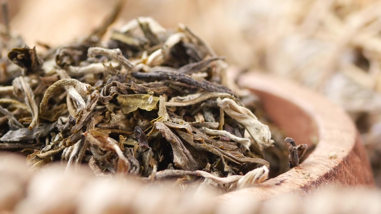 Dried Loose Leaf Tea in a Wooden Bowl
