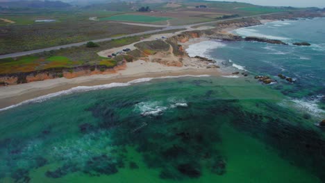 Pan-Down-Drone-shot-of-San-Gregorio-State-Beach-off-the-Pacific-Coast-Highway-in-California,-United-States