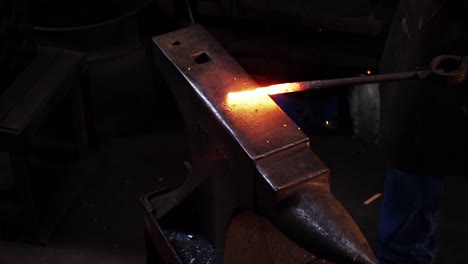 Mid-section-of-blacksmith-working-on-a-iron-rod