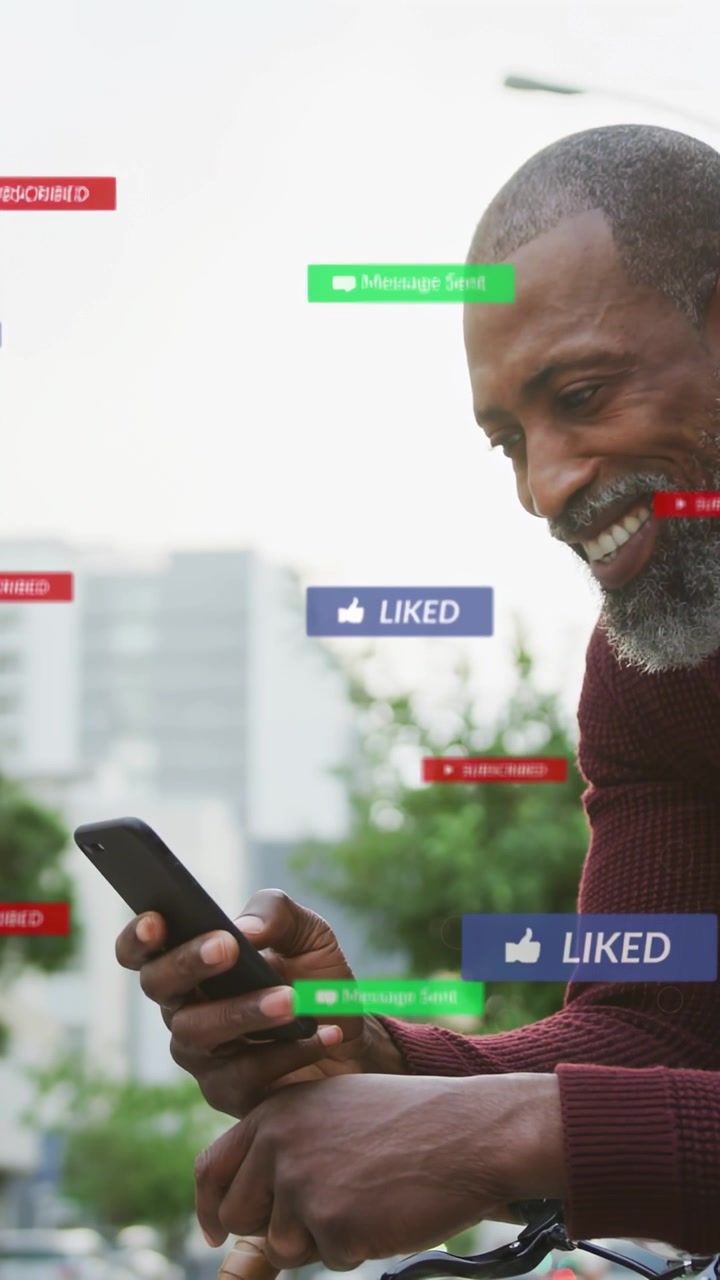 Vertical video: Mature man leaning on bike, tapping phone and making social badges pop, smiling