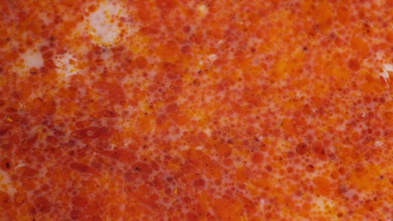 Macro close up of Asian white curry laksa oily soup moving