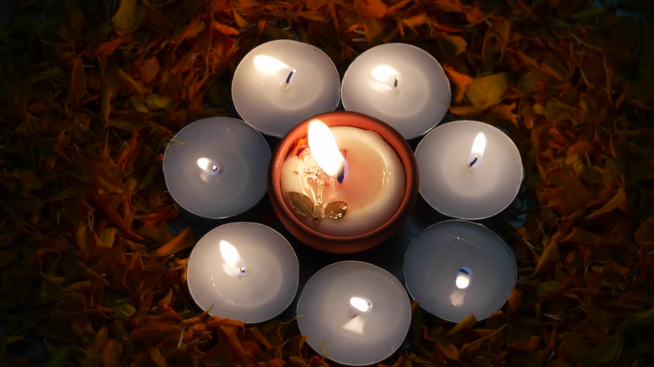 Strong wind and breeze blowning on tealight candles and Diyas or lamps lit up for Diwali 'Festival of light', important ancient Hindu festival celebrated signifying victory of light over darkness