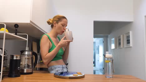 woman enjoying coffee and cookies in the kitchen