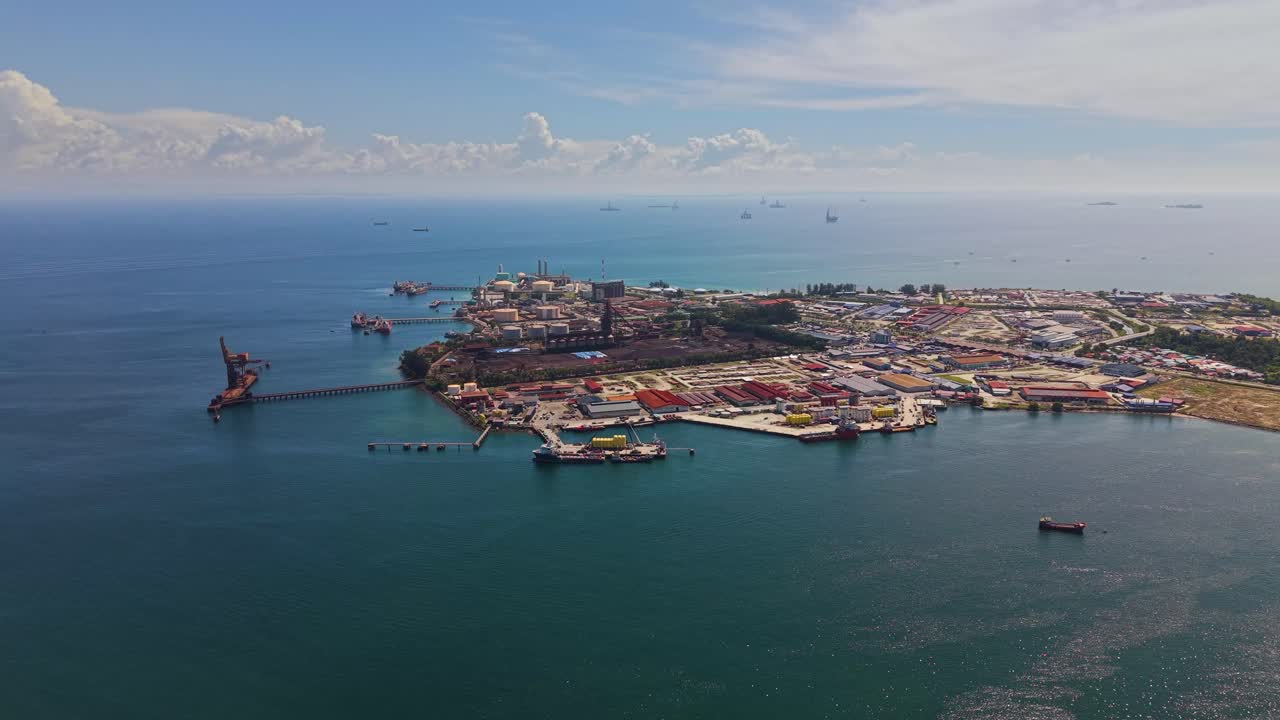 Aerial view of Labuan’s Rancha-Rancha Industrial Estate, Malaysia, featuring Petronas methanol plant, oil and gas facilities, storage tanks, and offshore supply ships in clear tropical waters