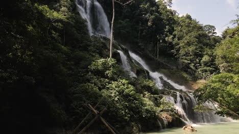 Lapopu-Waterfall-Surrounded-By-Lush-Vegetation-With-Bamboo-Bridge-View-At-Sumba-Island,-East-Nusa-Tenggara-Province-In-Indonesia