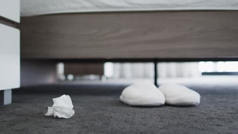 vista de papel de pañuelo usado cayendo de la cama al suelo