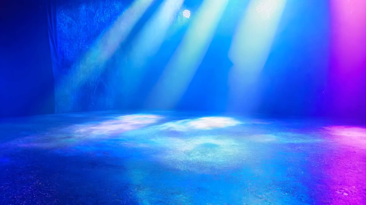 A large room with a blue, red, and purple light shining on the floor. The room is empty and the light is creating a colorful and vibrant atmosphere