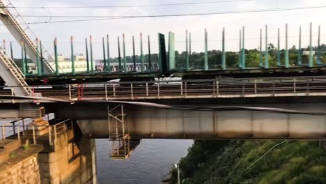 Crossing-a-bridge-with-while-sitting-in-the-train-and-seeing-cargo-train-riding-to-oposite-side