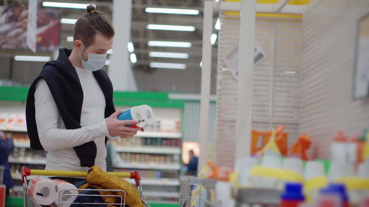 Man Shopping for Toilet Paper in a Supermarket During the Pandemic