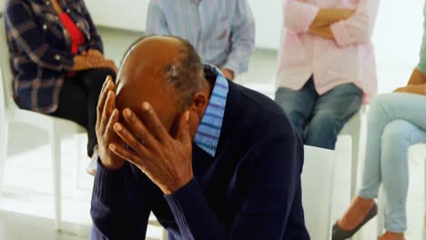 senior man sitting at health center 4k