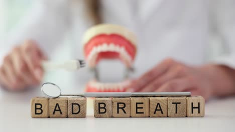bad breath concept with dental model and tools