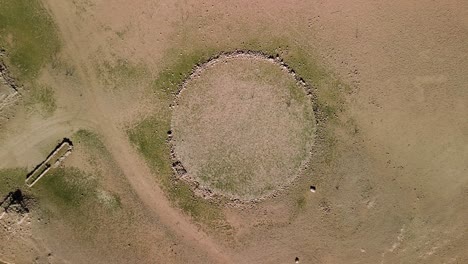 aerial view of ancient stone circle ruins in dry lake bed