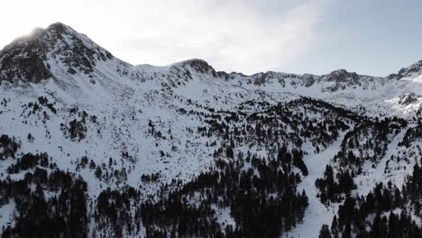 beautiful snow covered mountains with sun lens flare in pyrenees