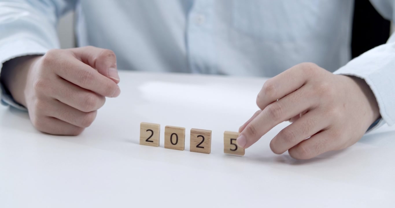 Professional changing year from 2024 to 2025 with wooden puzzle pieces and numbers, symbolizing successful yearly business planning, achievement, and growth in a corporate setting