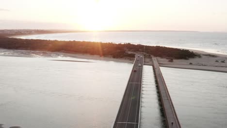 aerial over barwon heads bridge, australia with an autumn sunrise